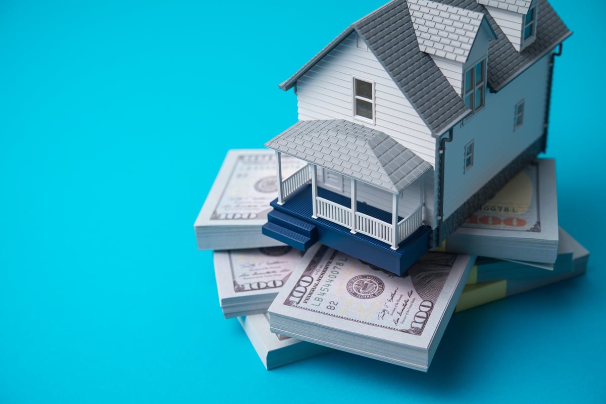 House model with dollar bills representing home financing options