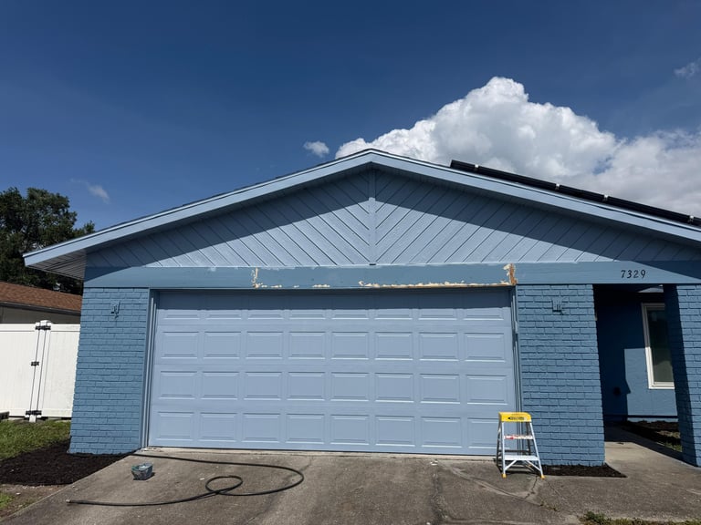 Bradenton garage-front exterior before coating, with worn fascia finish.