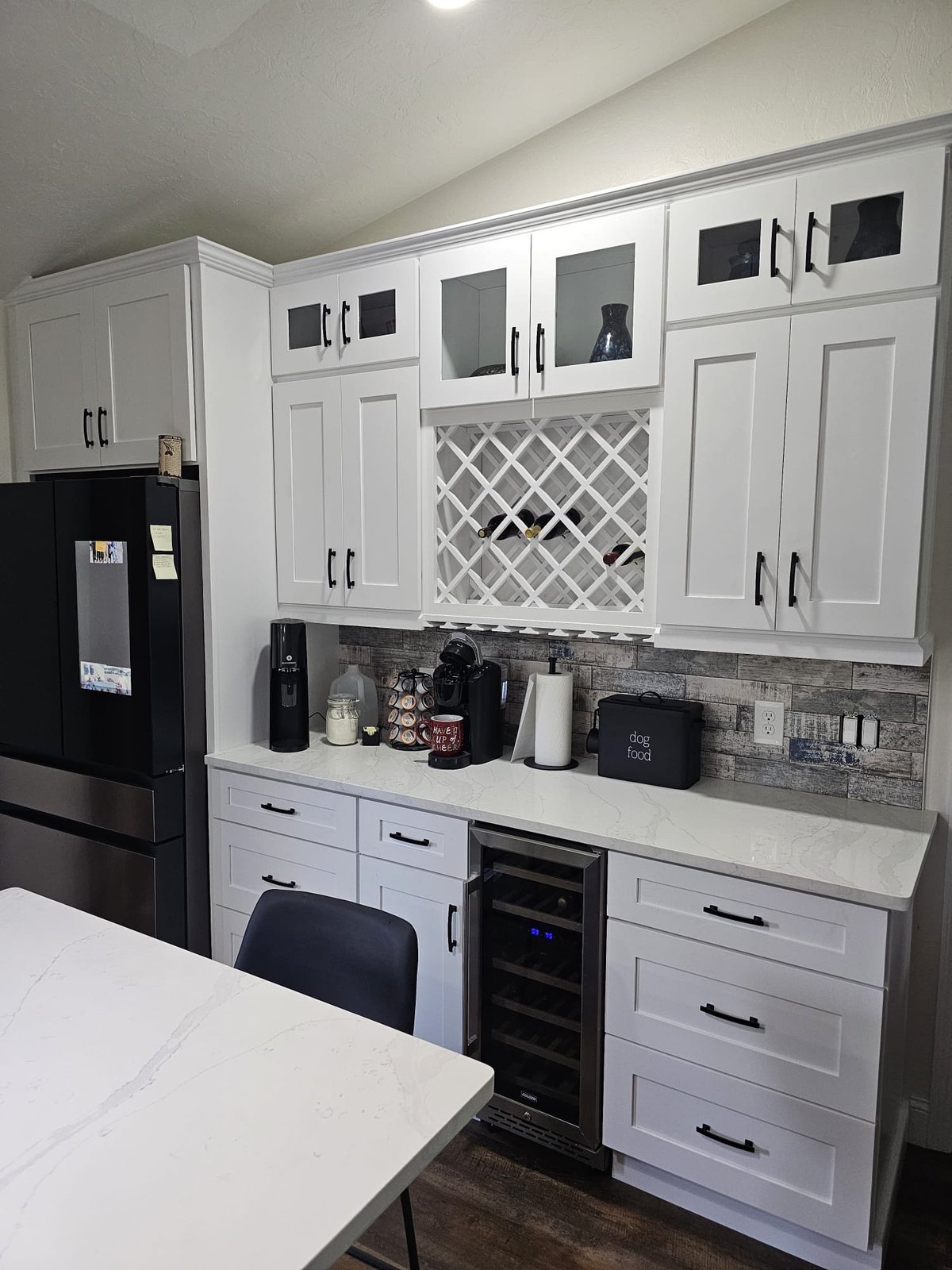 Built-in gray cabinetry with a dark countertop and under-counter beverage refrigerators