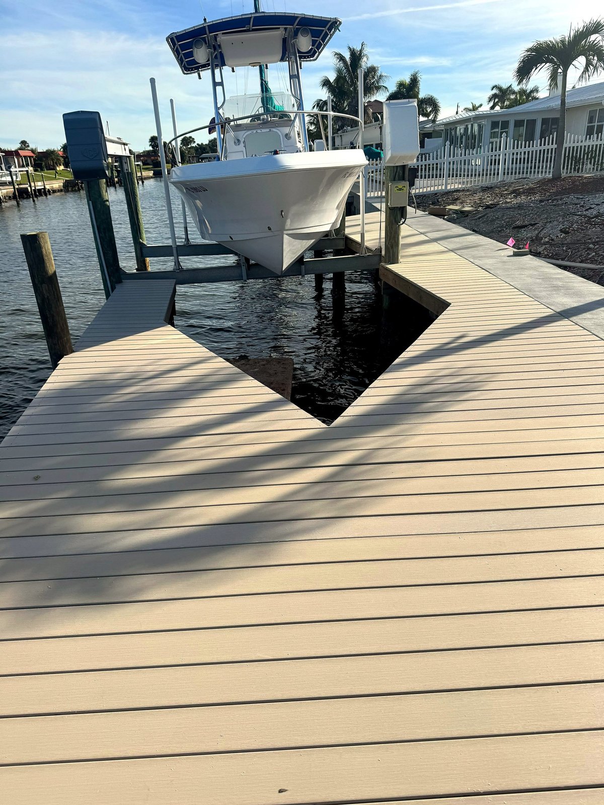 Composite dock decking surrounding a boat lift at a Southwest Florida waterfront property.