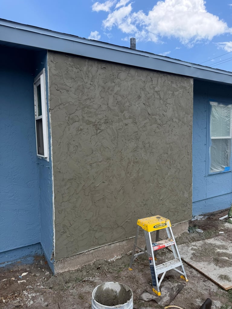 Exterior stucco preparation on a Bradenton home before coating.