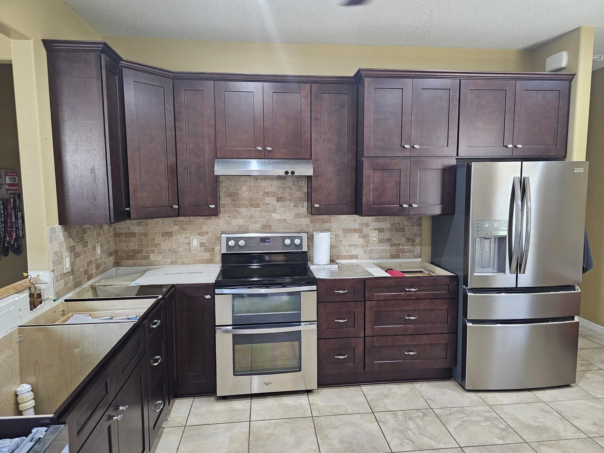 White kitchen beverage station with glass-front display cabinets, wine storage and a beverage refrigerator