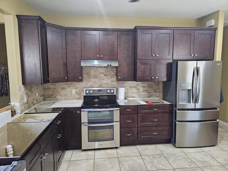 White kitchen beverage station with glass-front cabinets, wine storage and beverage refrigerator.