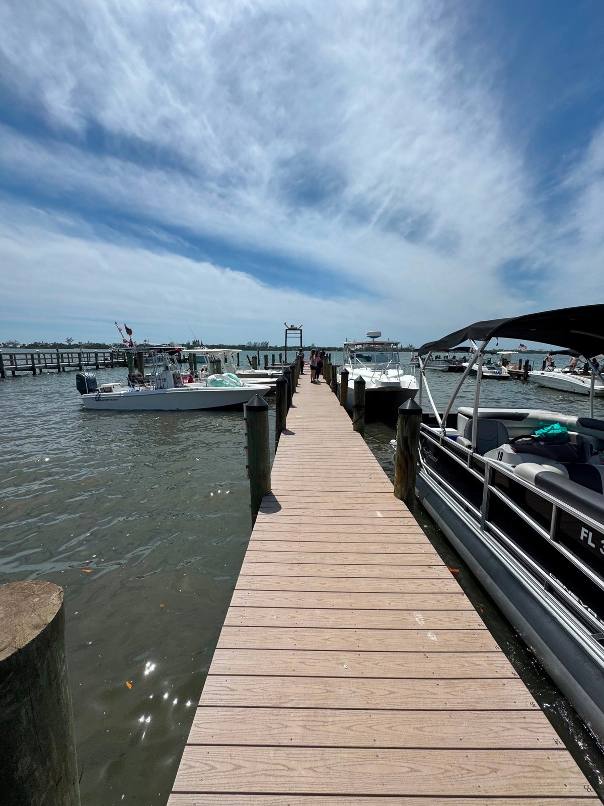 Renovated Spanish Point dock walkway with boats alongside in Osprey.