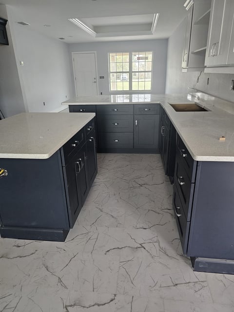 Two-tone kitchen cabinetry with white upper cabinets and dark base cabinets.