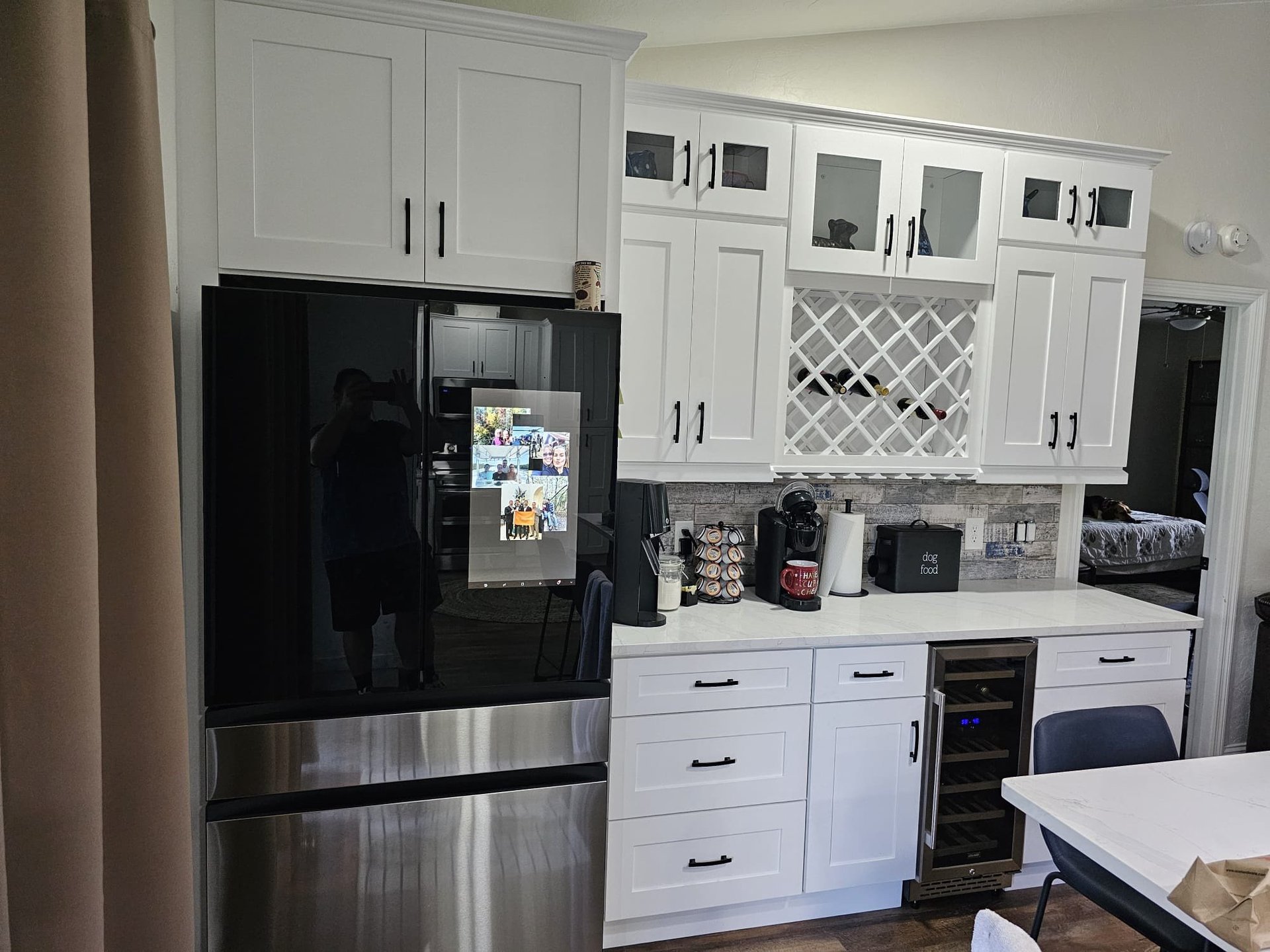 Gray built-in beverage bar with tall storage cabinetry, glass-front display cabinets and a beverage refrigerator